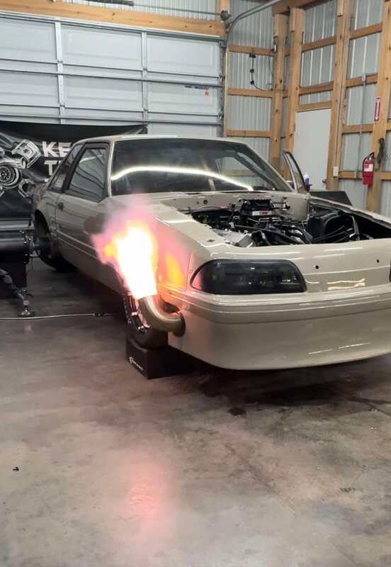 A tan Fox body notchback in the shop under the Kessel's Tuning banner, flame off the dump pipe