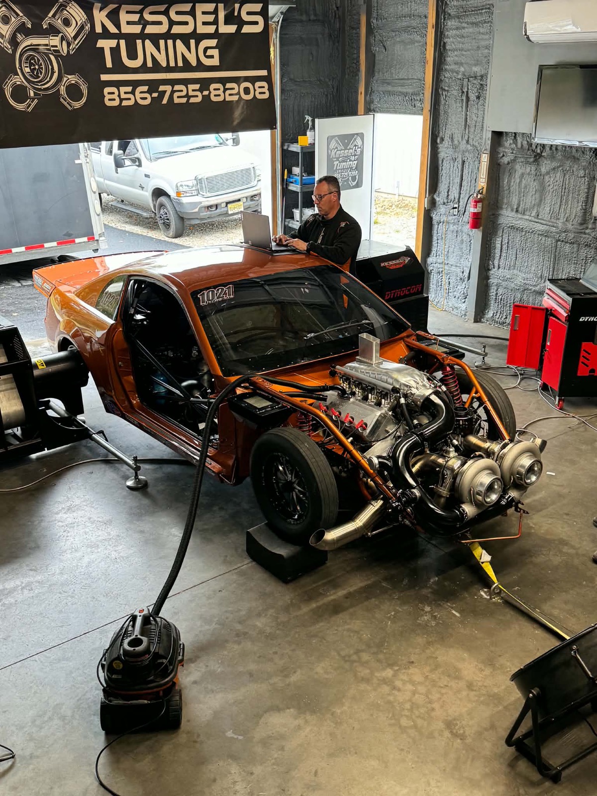 Bill Kessel at the laptop tuning a car on the dyno at the shop in Monroeville, New Jersey