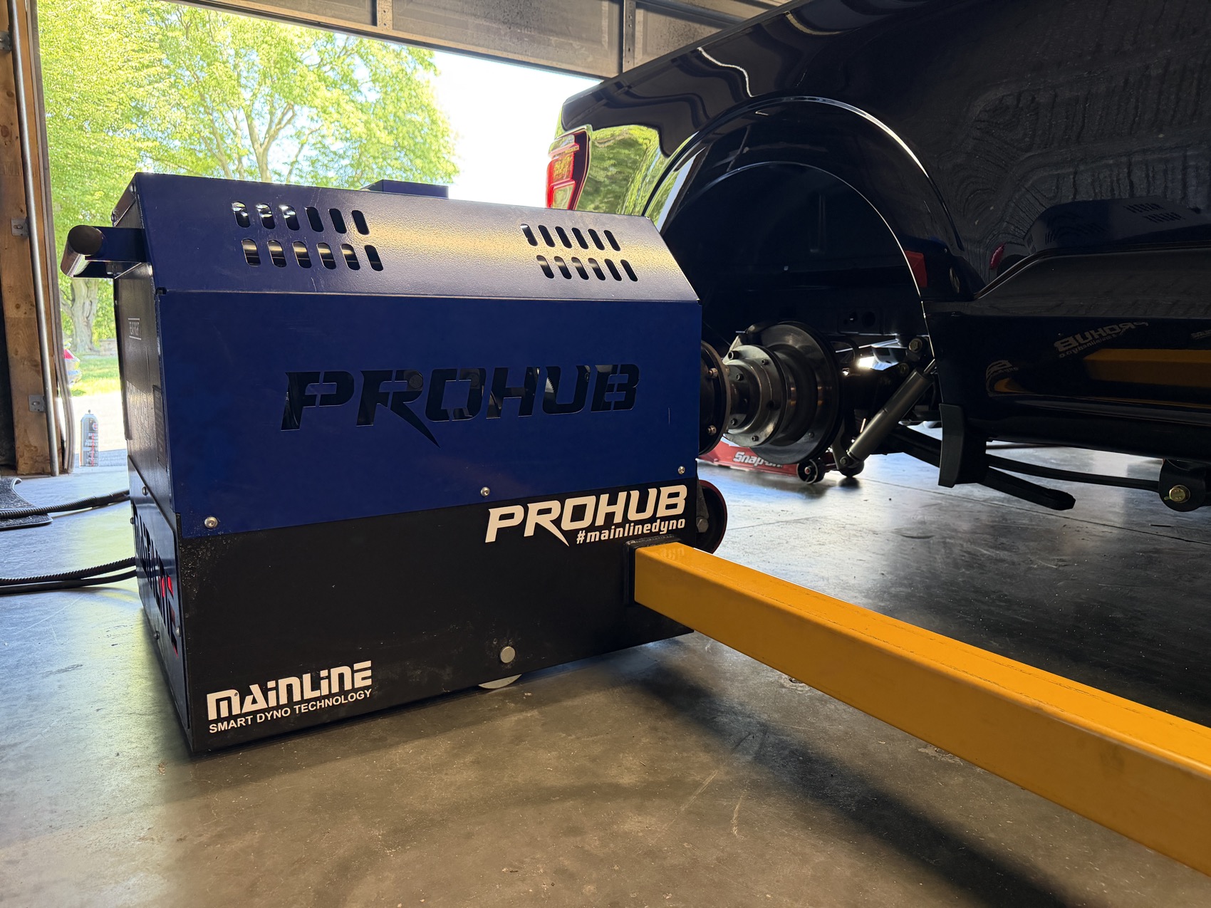 The shop ProHub dyno unit in the bay, with a car hub mounted to it